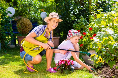 Landscape worker wearing PPE while carrying out garden maintenance